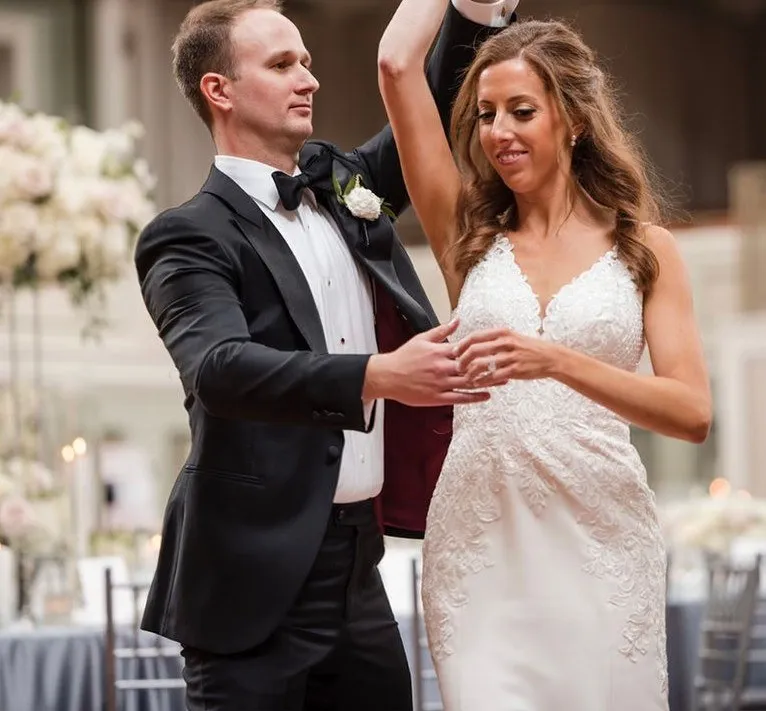 A groom spins his bride during their first dance at a Nashville reception