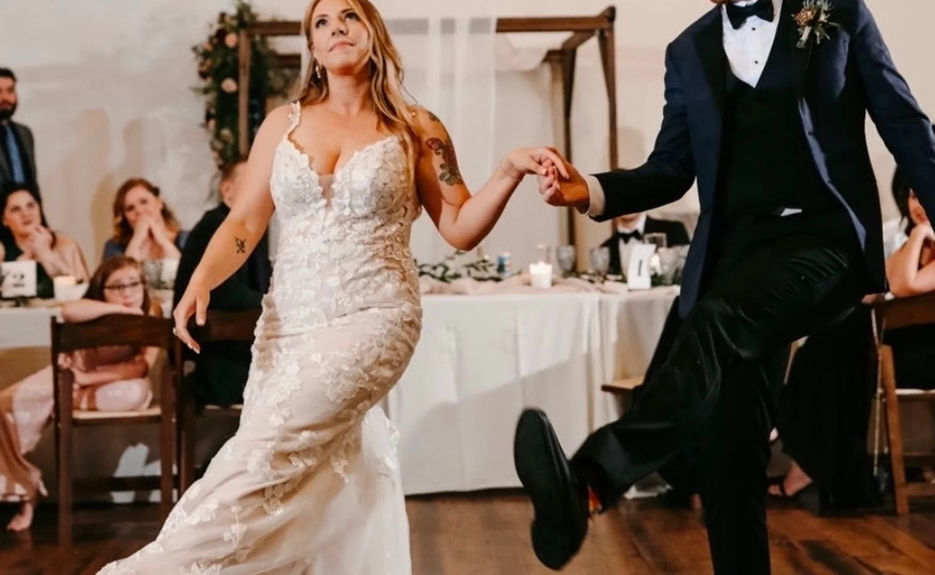A bride and groom sharing their first dance under sparkling lights